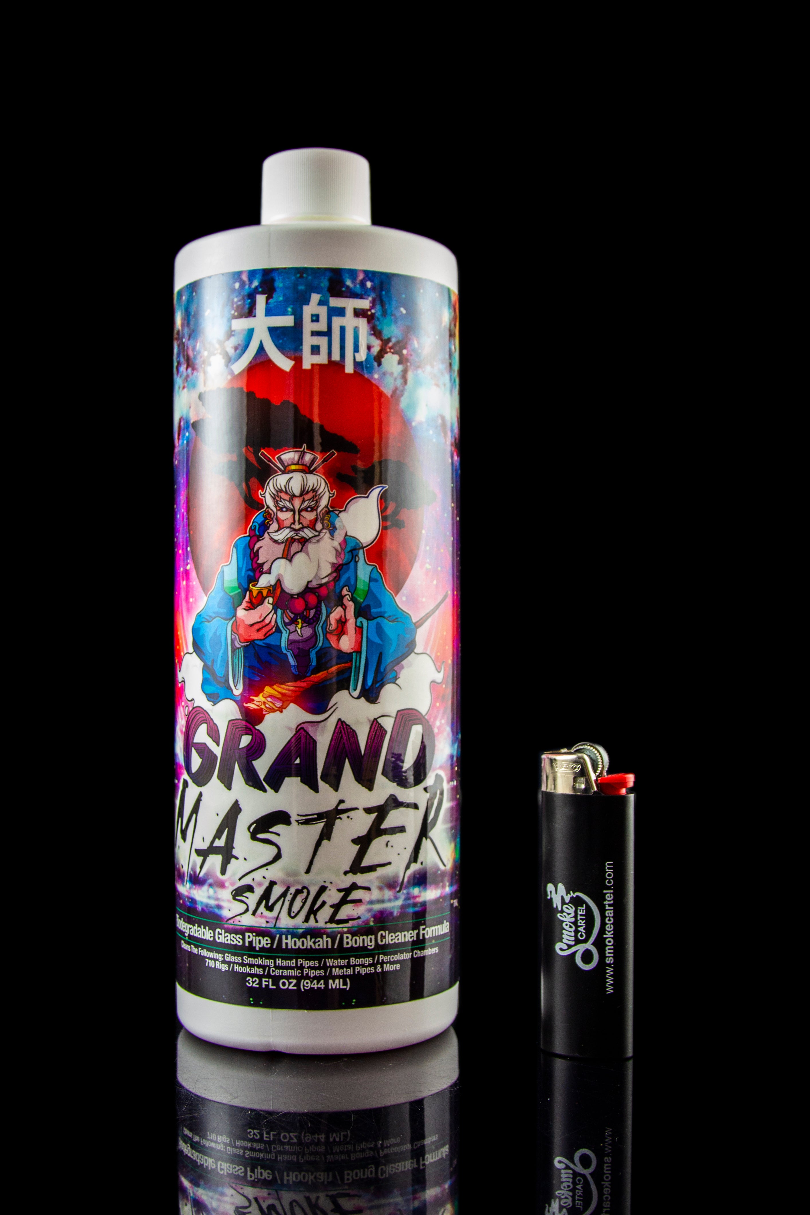 A bottle of “Grand Master Smoke” cleaning solution for pipes and bongs, positioned next to a lighter, against a dark reflective surface."