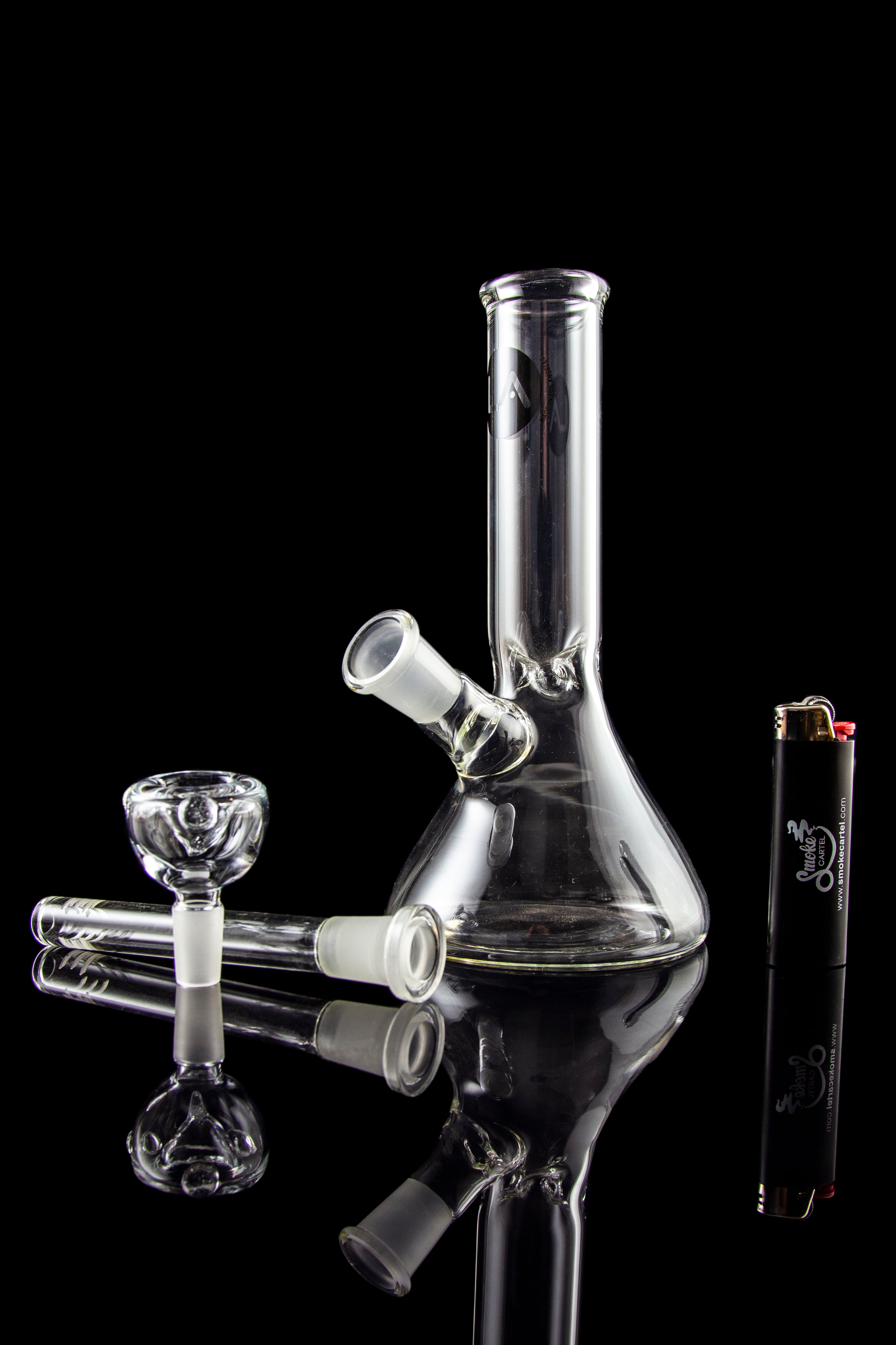 A studio shot of the LA Pipes Basic Beaker Water Pipe - Simply Guy, showcasing its clear glass construction in a downward-angled view.