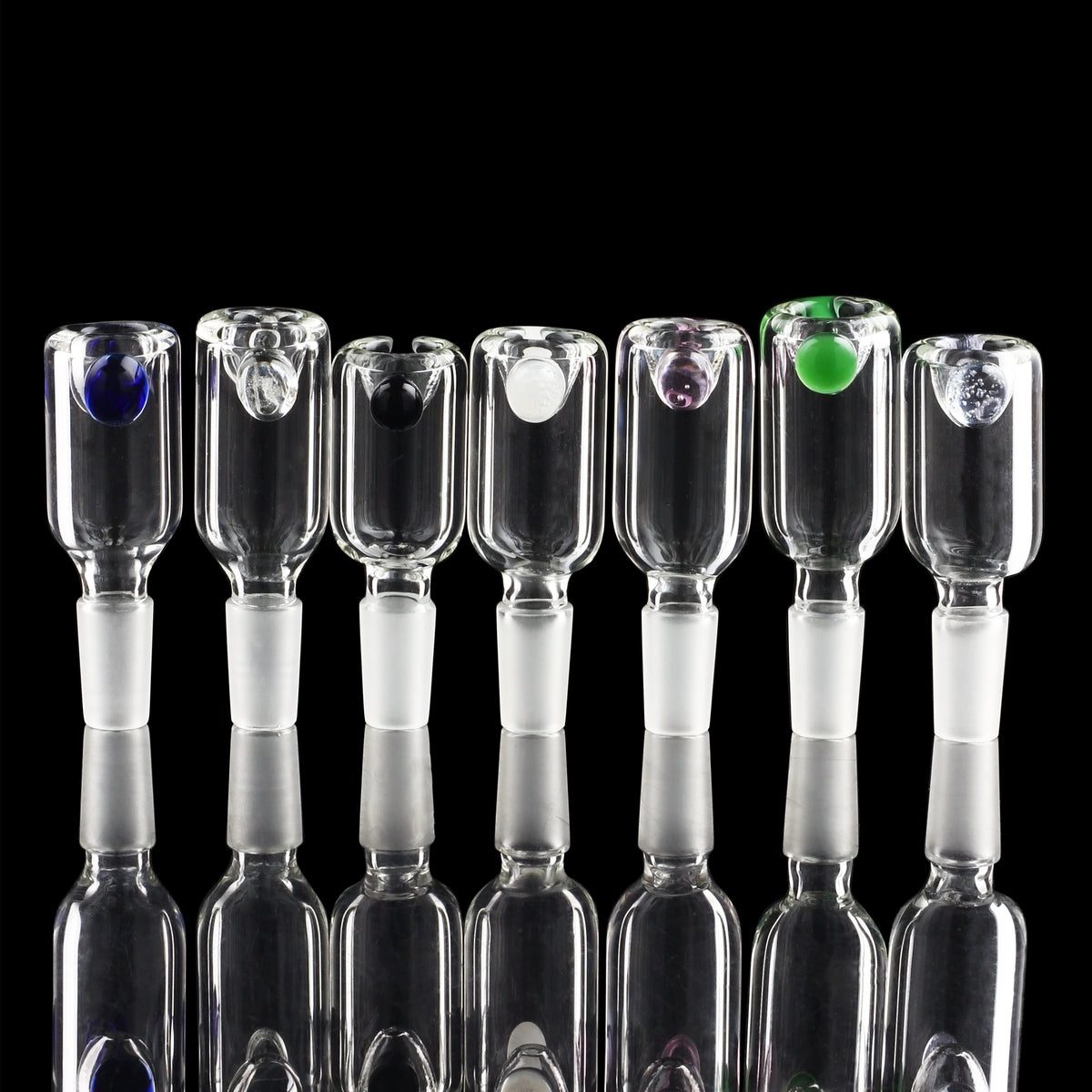 A row of clear glass bubblers with uniquely colored accent pieces, likely for cannabis use.