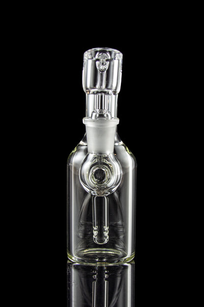 Clear glass bubbler water pipe with intricate design, reflecting on a black surface.