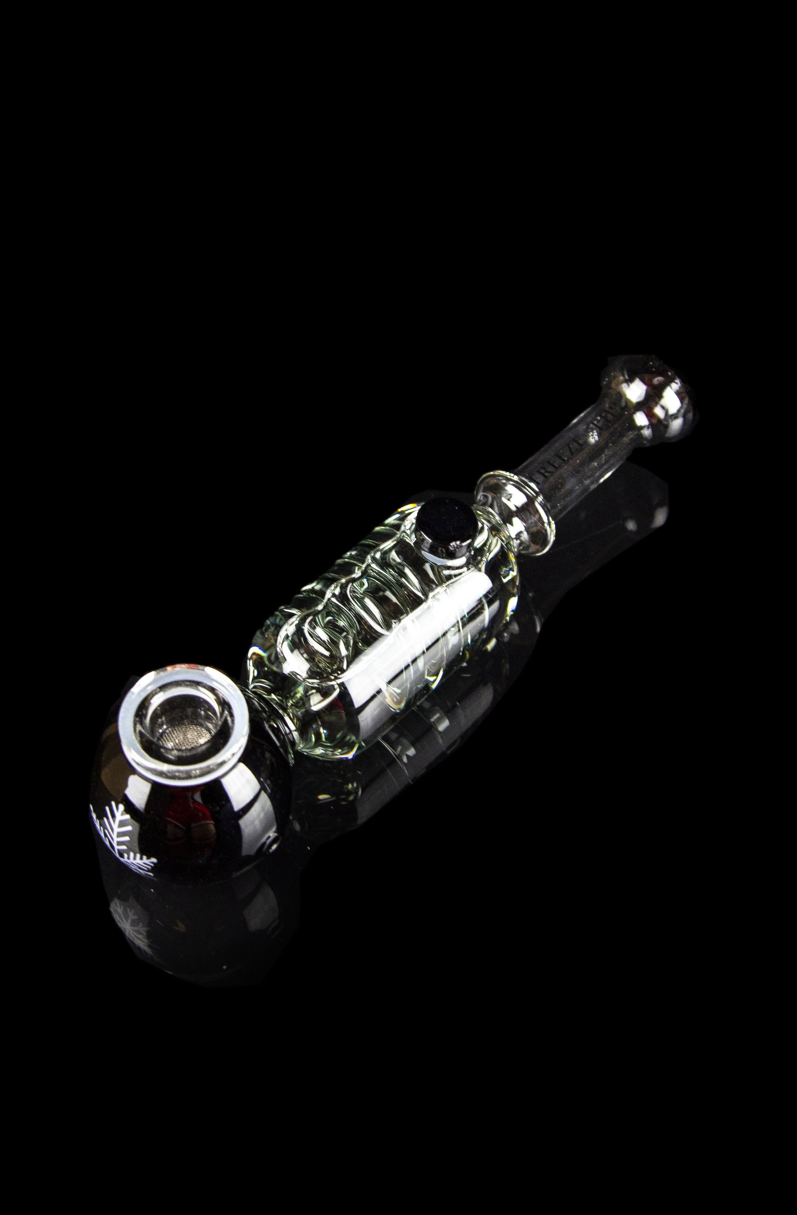 Glass cannabis pipe with intricate green and clear glasswork against a black background.