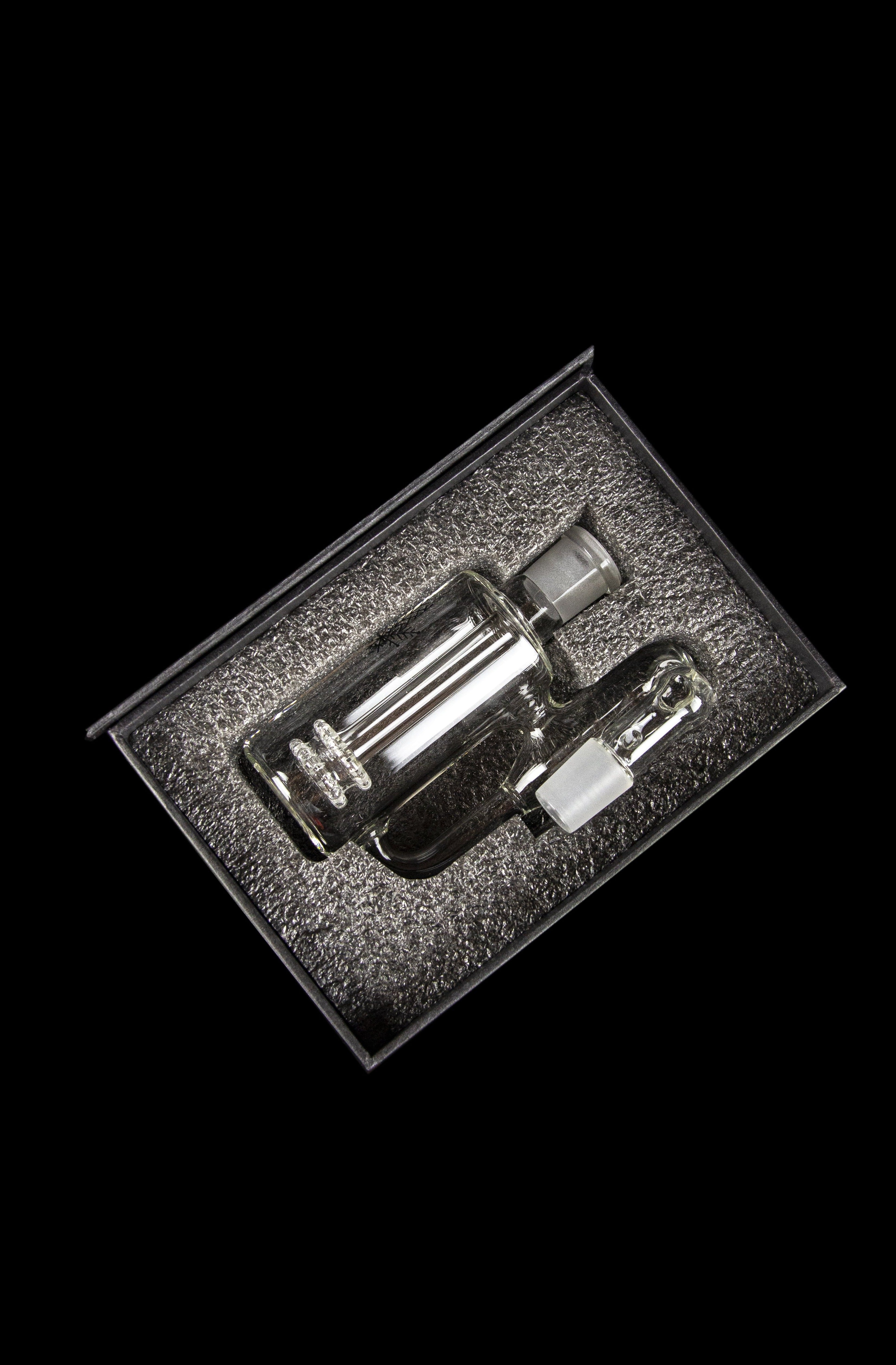 Clear glass dab rig displayed in a foam-lined case.