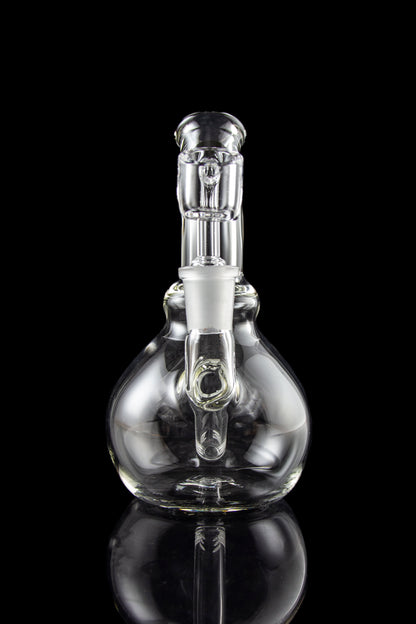 A studio shot features the LA Pipes Mini Bubble Base Concentrate Rig in clear glass, reflected on a dark surface.