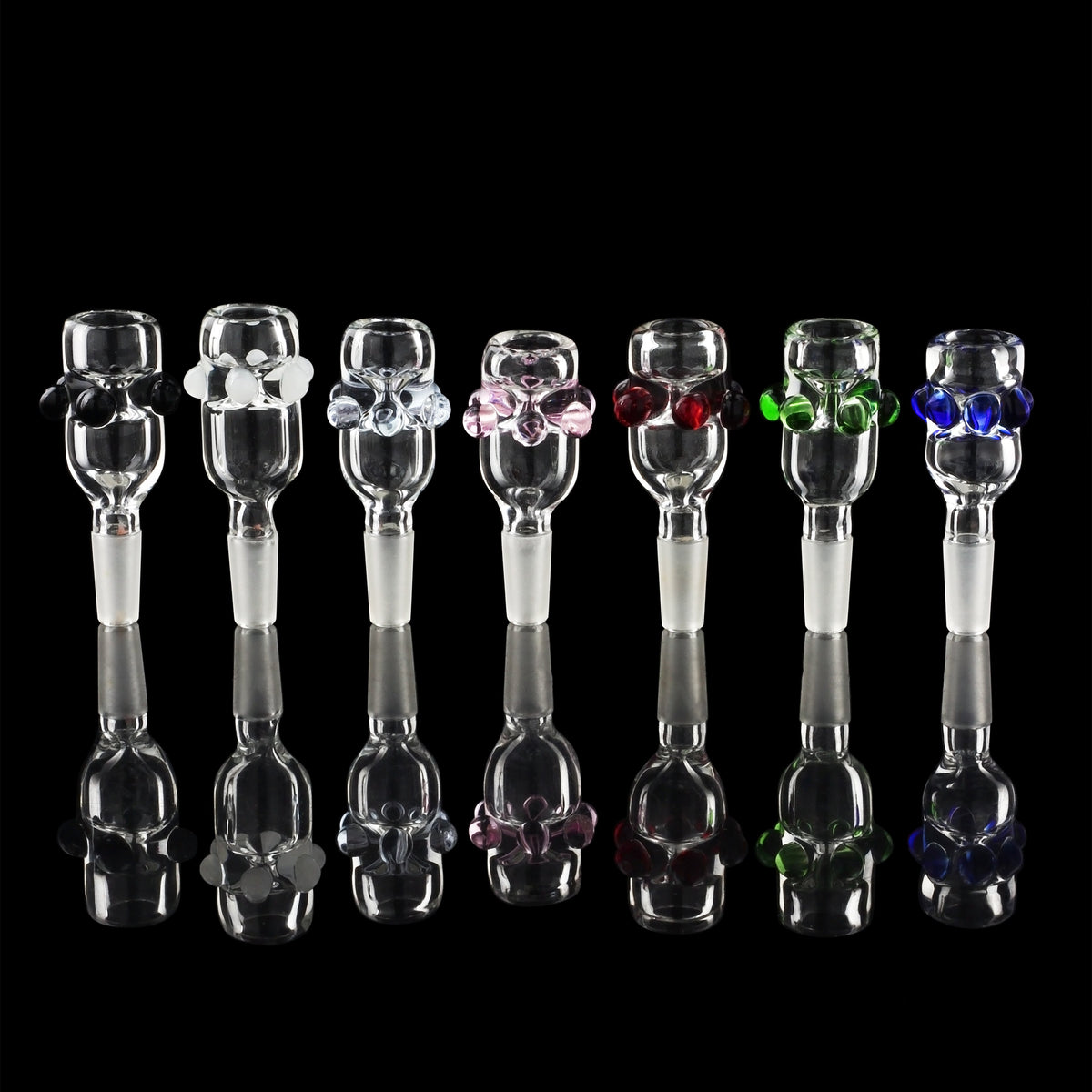 A row of colorful glass smoking pipes (bongs) against a black background.