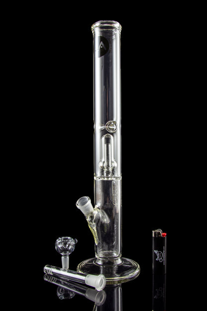 Glass bong with accessories and lighter on black background.