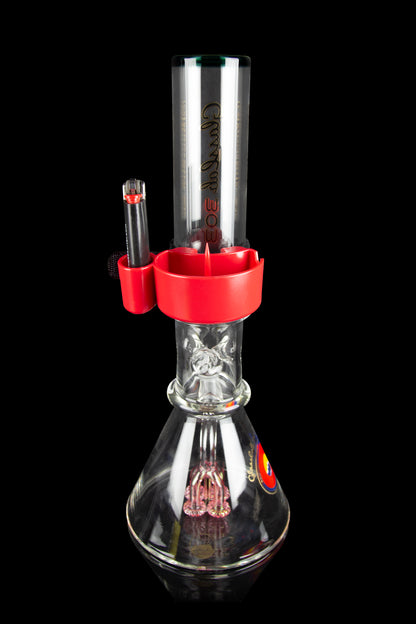 Red and clear glass water pipe (bong) with intricate percolator design, studio shot on black background.