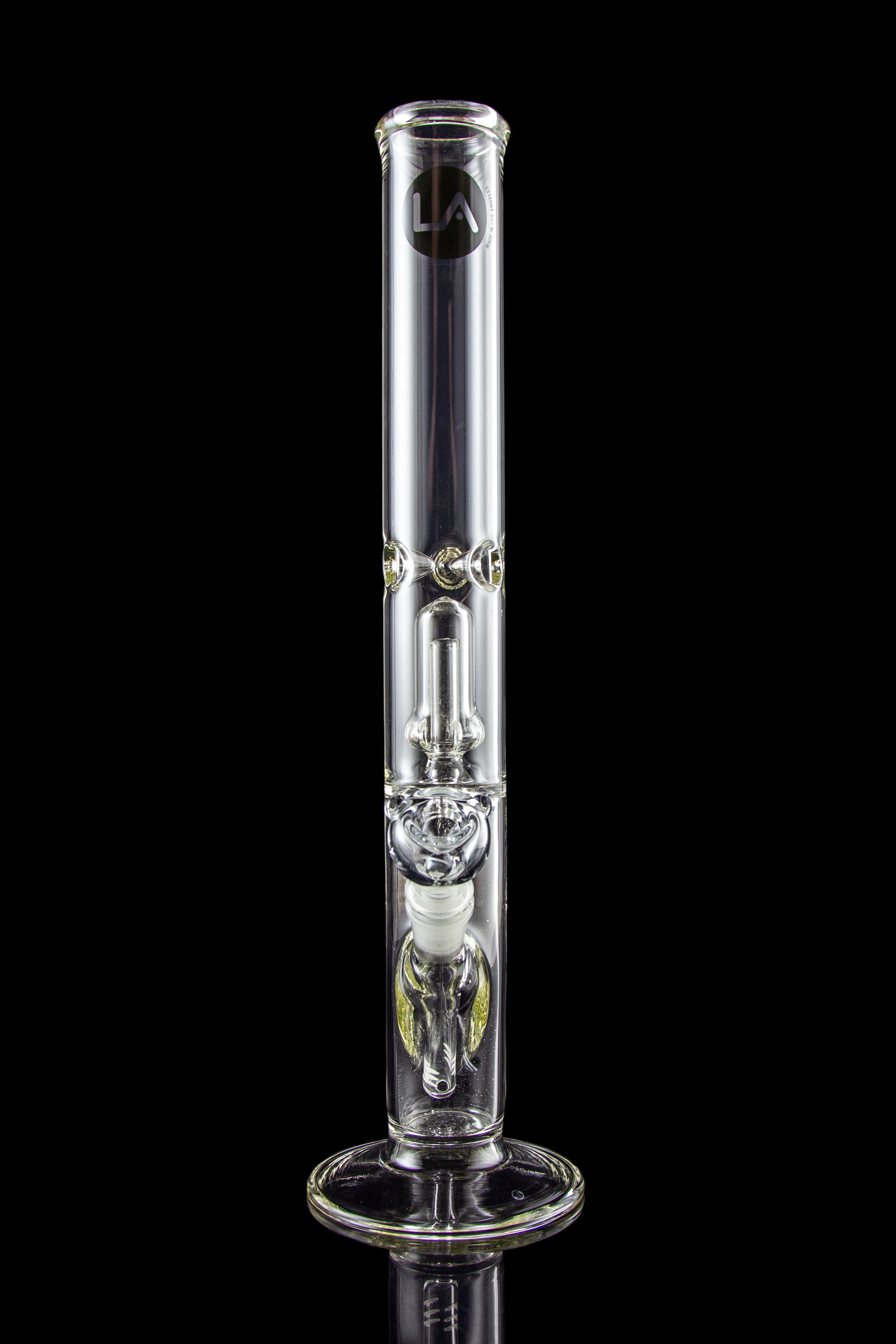 Clear glass bong with intricate percolators, isolated on a black background.