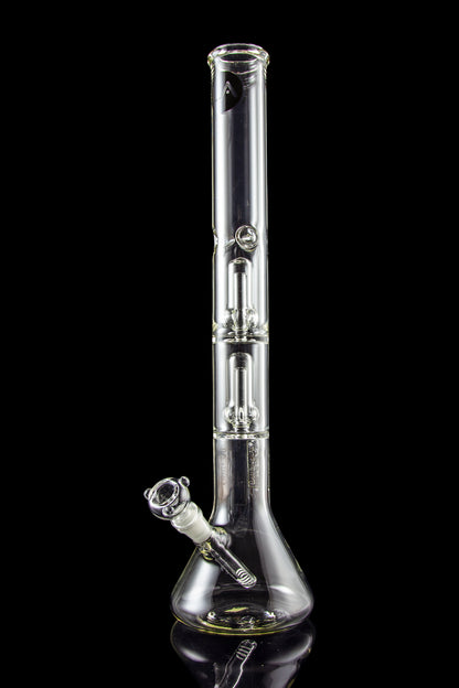 Clear glass bong with intricate bubbler and reflective surface against a black background.