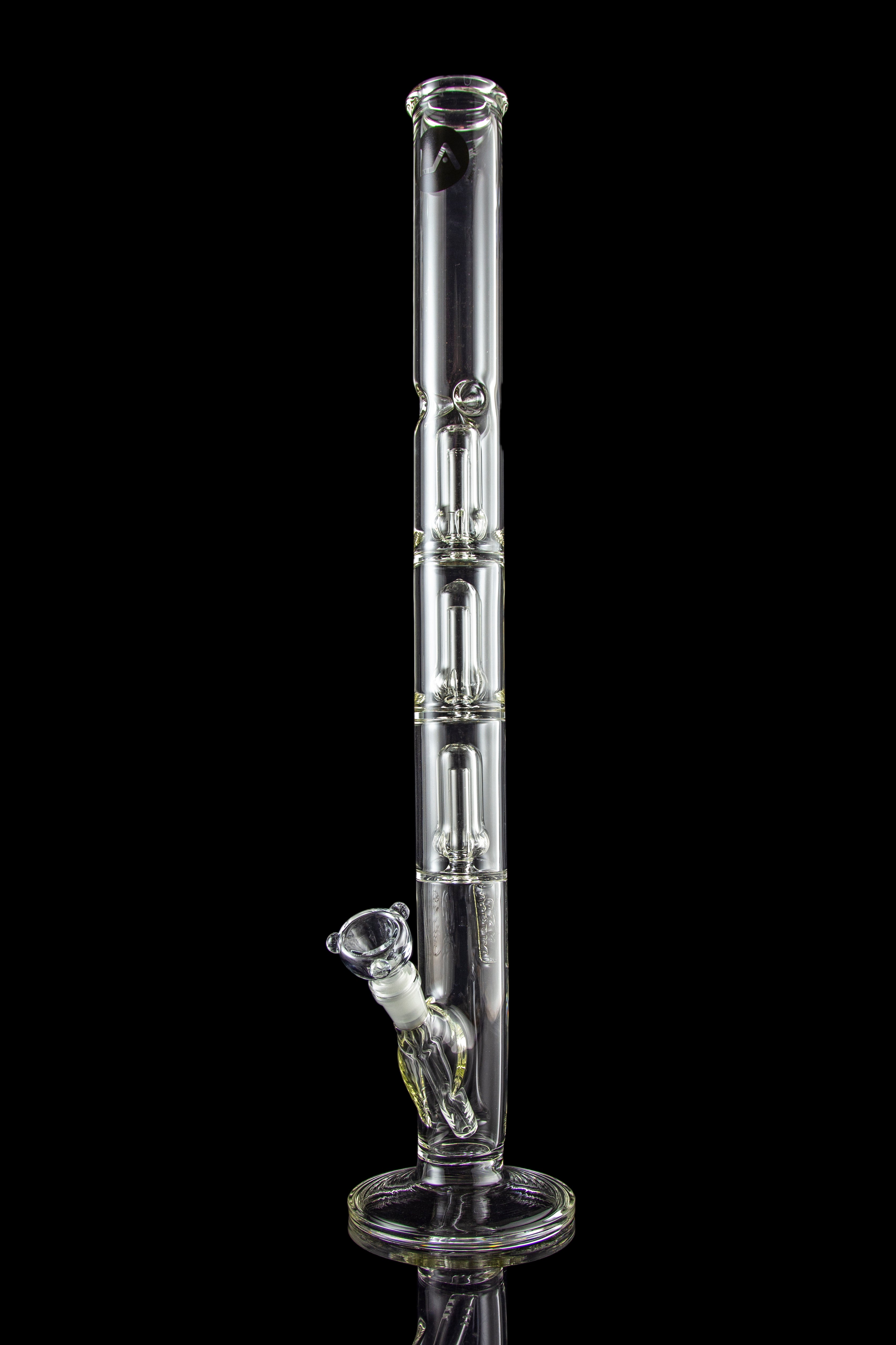 A tall, clear glass bong with multiple chambers and a glass bowl, isolated on a black background.
