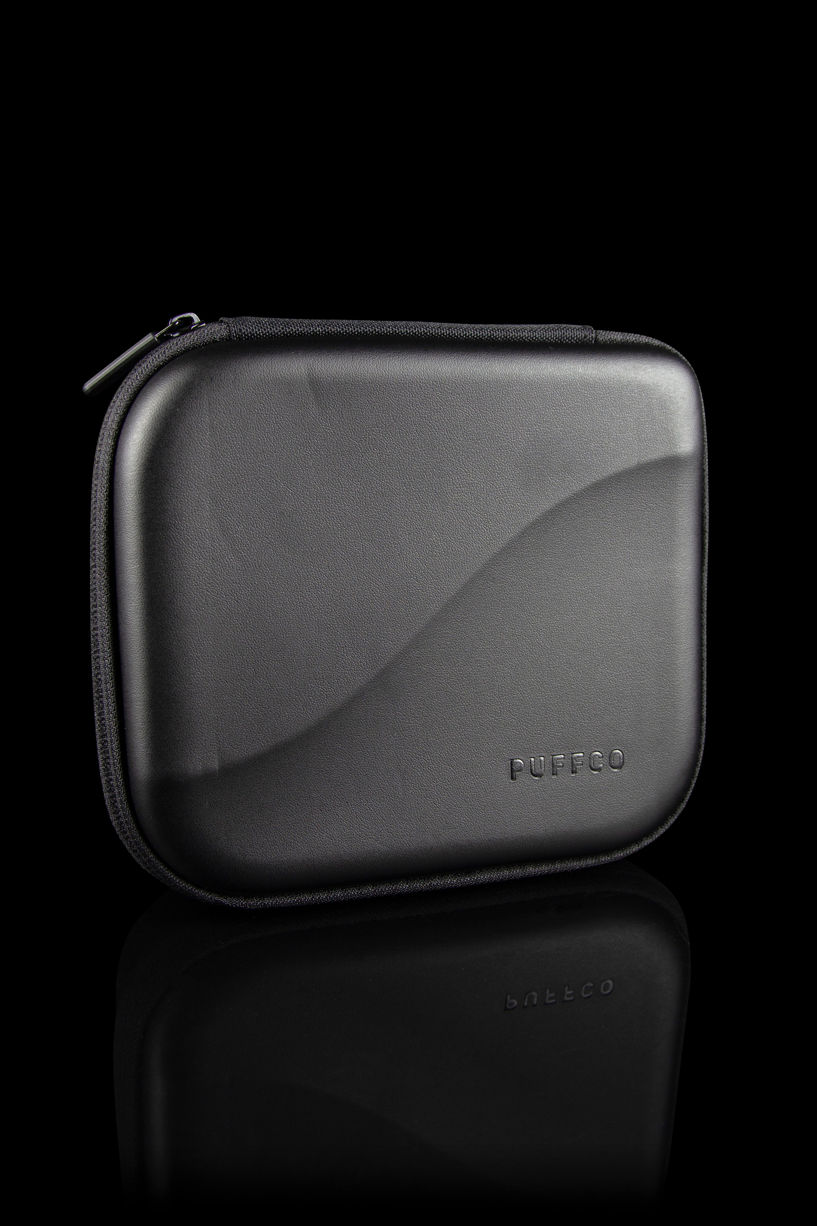 Black carrying case for a cannabis concentrate device, branded "PUFFCO".