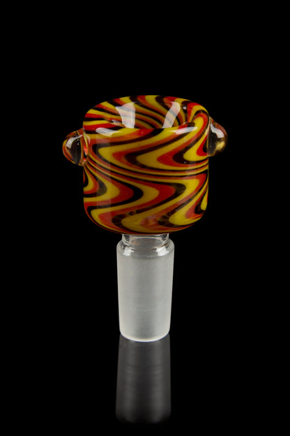 Close-up front view of the Honeybee Herb Wig Wag Flower Bowl showing swirling red, yellow, and black wig-wag patterns against a black background