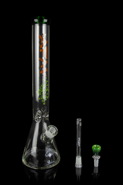 Glass bong with orange and green leaf designs, displayed with a downstem and bowl.