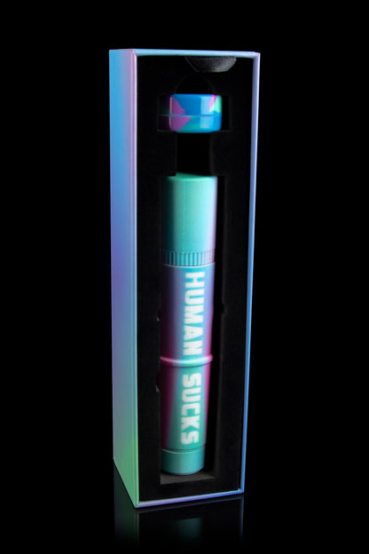 Neon green and pink cannabis pen in a black display case with the text "HUMAN SUCKS" vertically displayed.