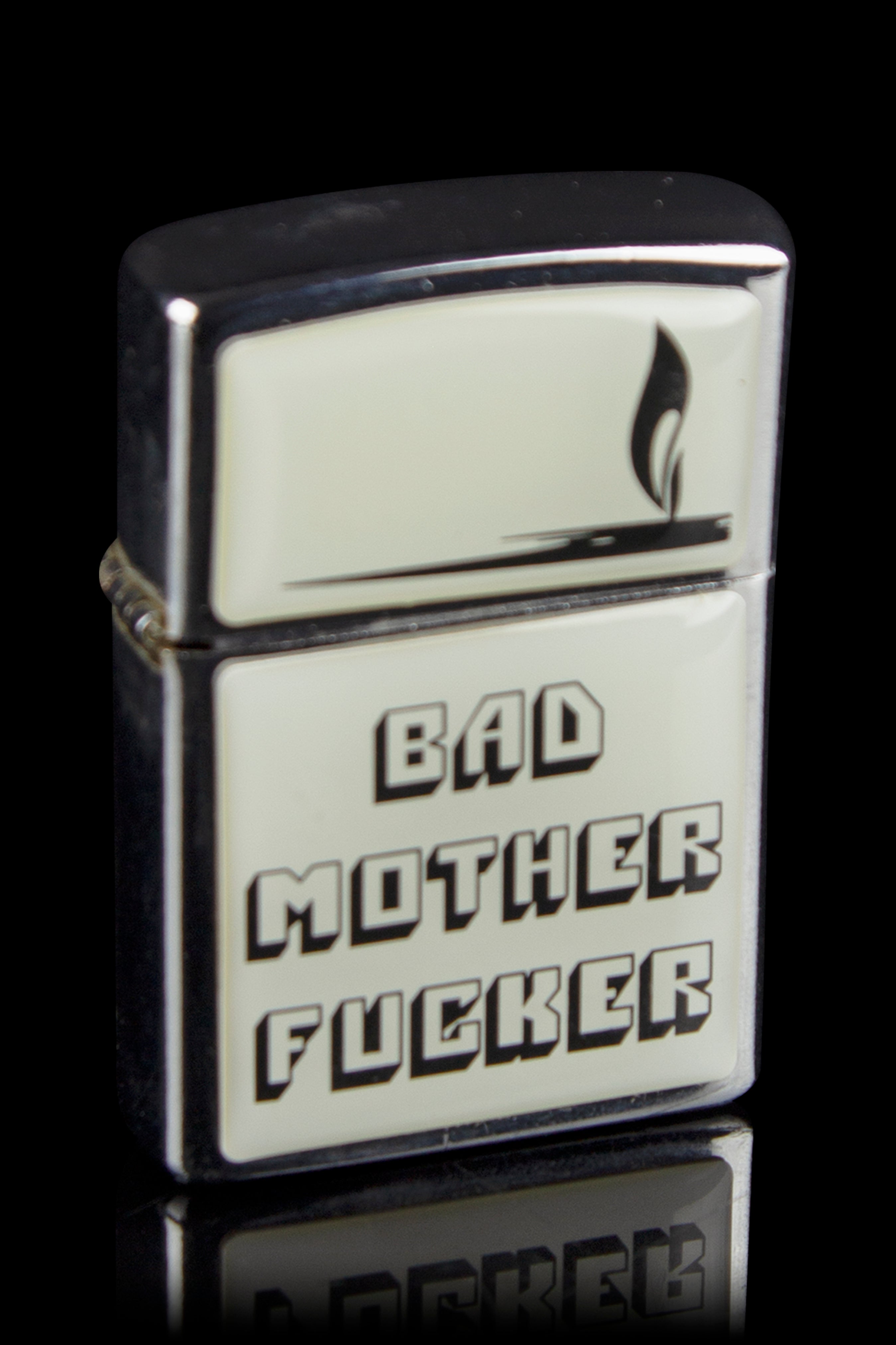 Silver Zippo lighter with bold black text reading “BAD MOTHER FUCKER” and a flame icon.