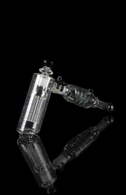 Clear glass water pipe (rig) with intricate percolators against a black background.