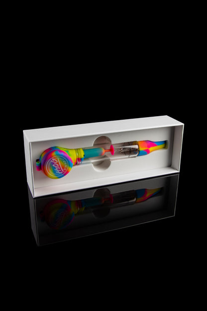 Colorful glass cannabis dab rig displayed in a white box with a reflective base.