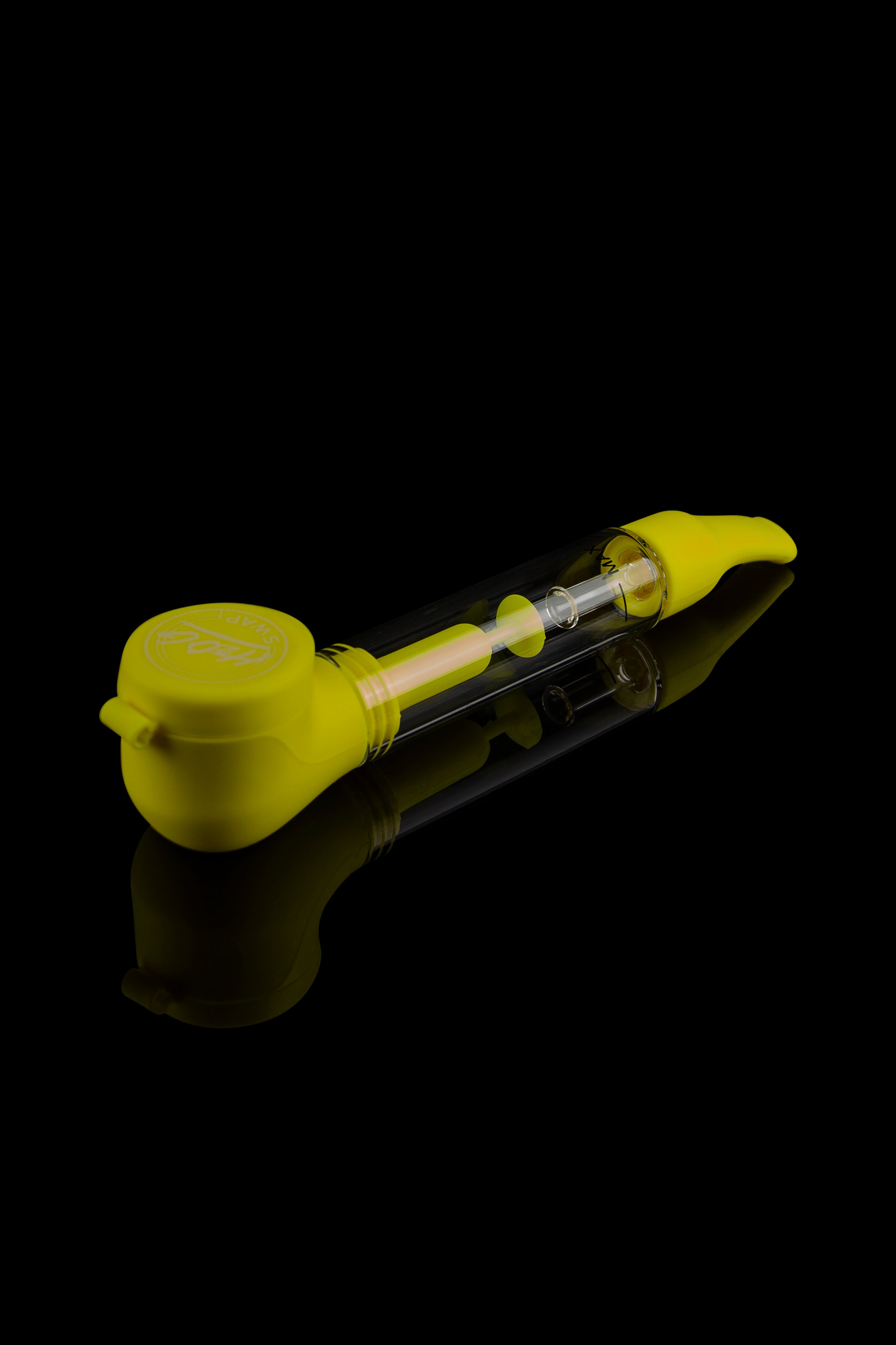 Yellow glass bubbler pipe with a clear glass chamber, reflecting on a black surface.