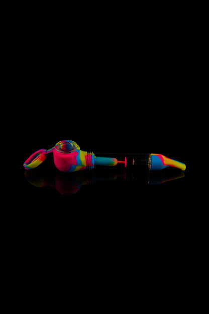 Colorful silicone cannabis pipe on a reflective surface.