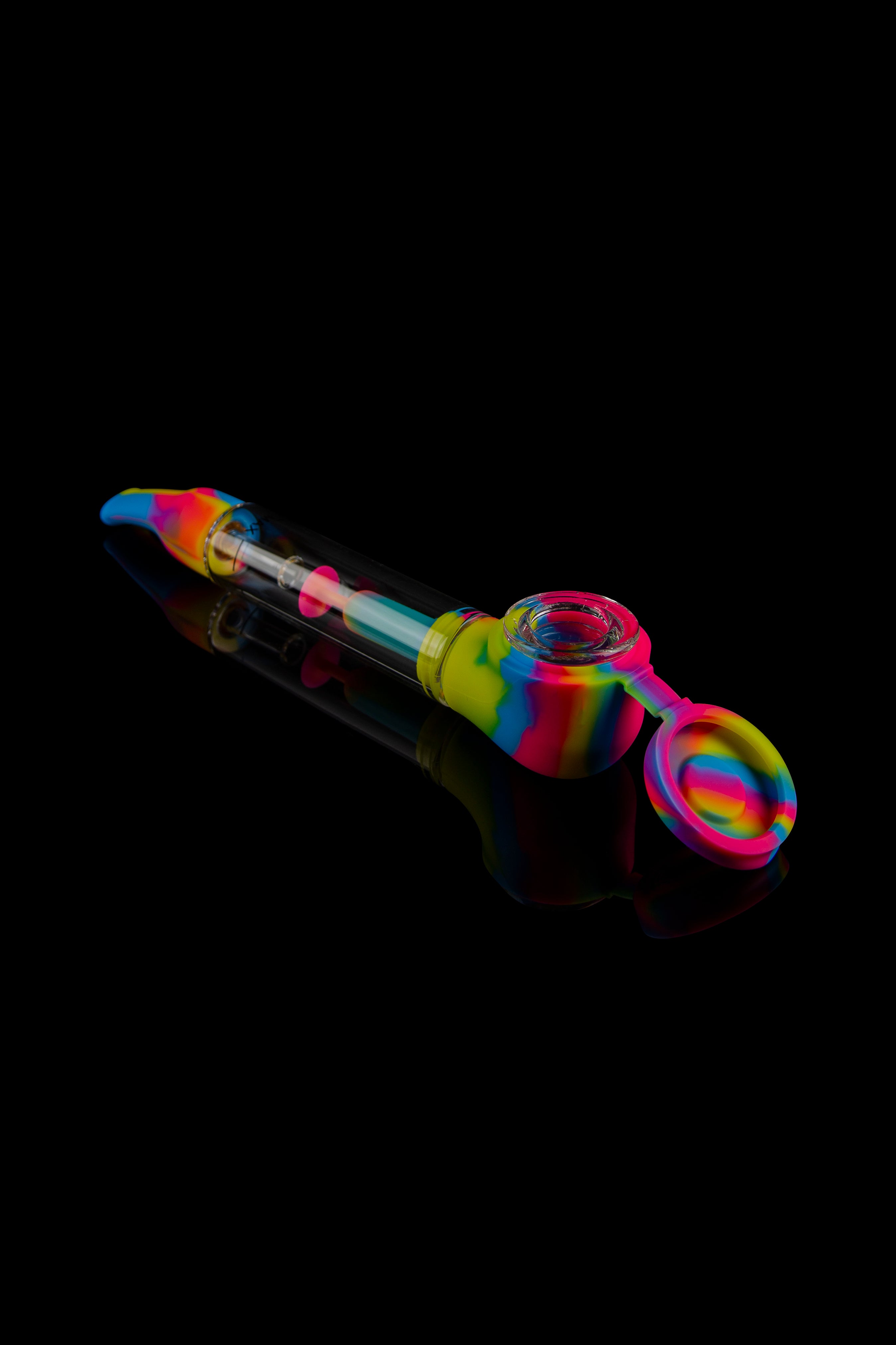 Colorful silicone oil rig with glass bowl against a black background.