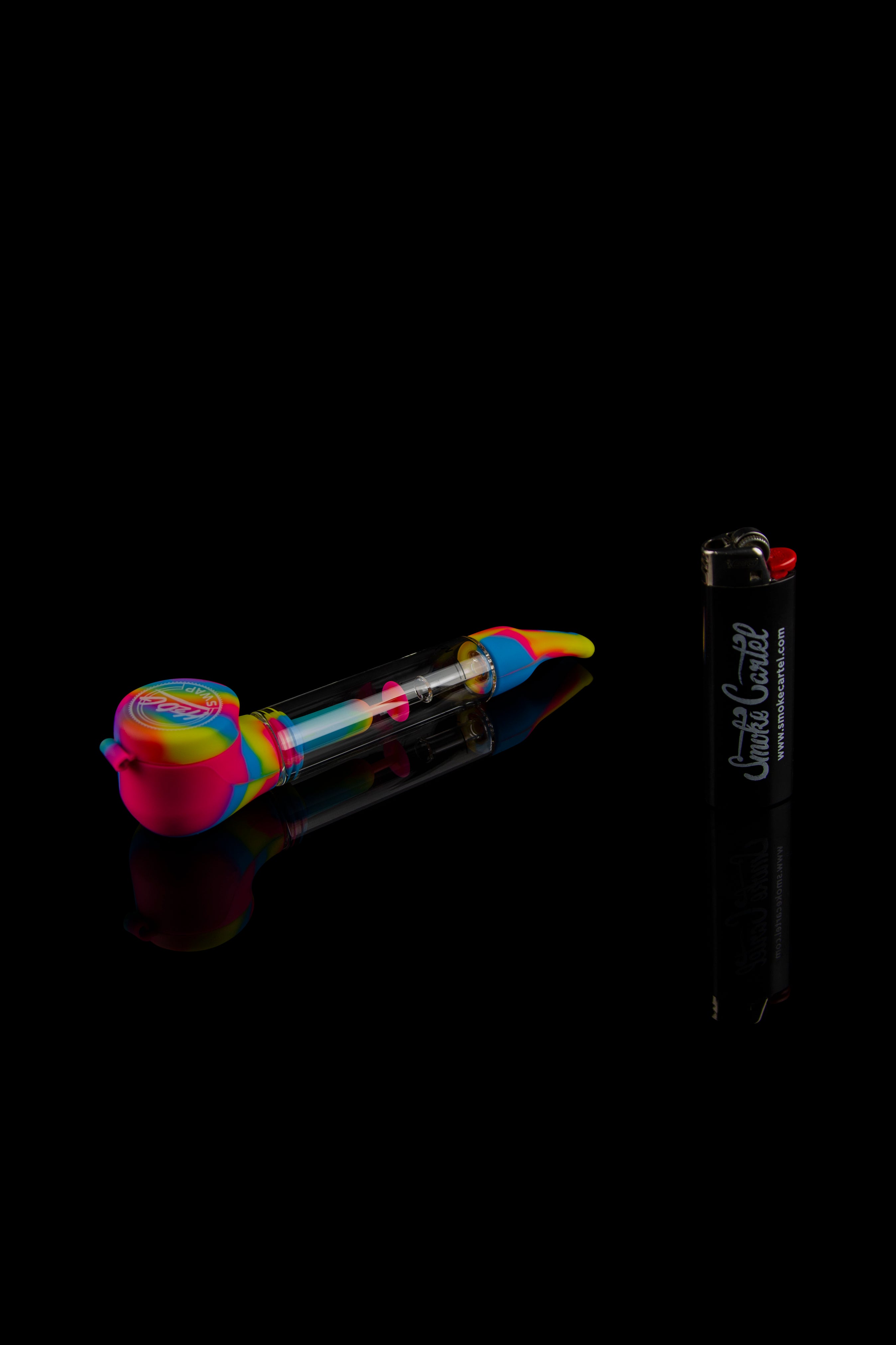Colorful glass bubbler pipe and lighter on black background.