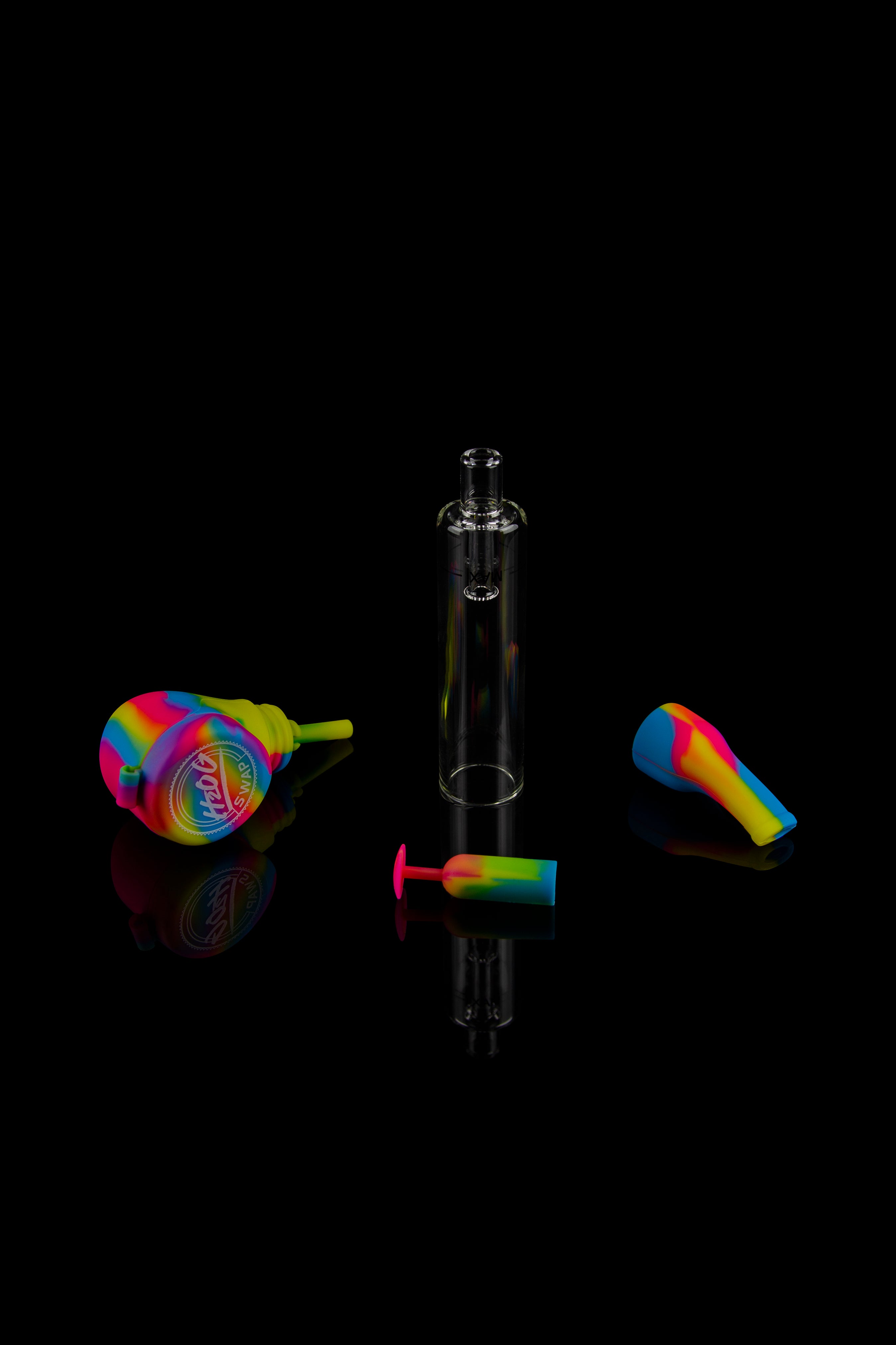Colorful cannabis rig with glass and silicone attachments on a black background.