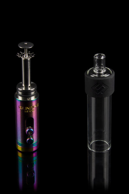 Colorful cannabis e-rig and glass water pipe reflecting on a black surface.