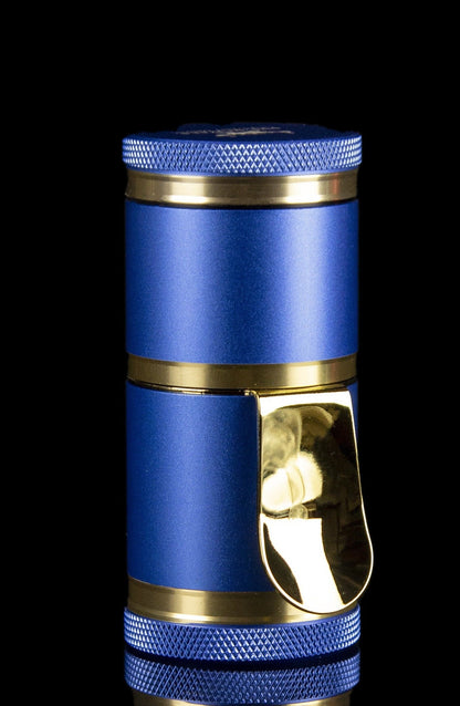 Blue and gold cannabis grinder with a visible chamber.