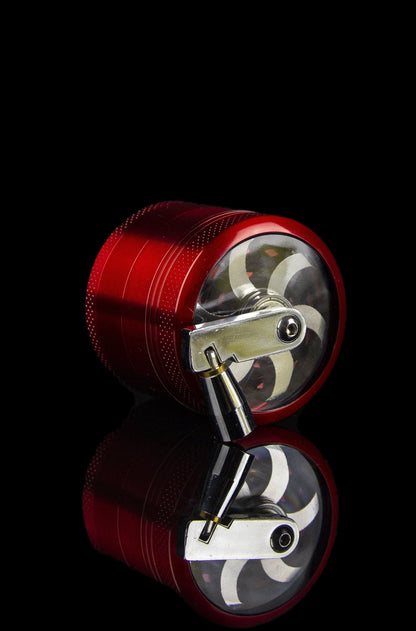 Red cannabis grinder disassembled, revealing the internal grinding mechanism against a black background.