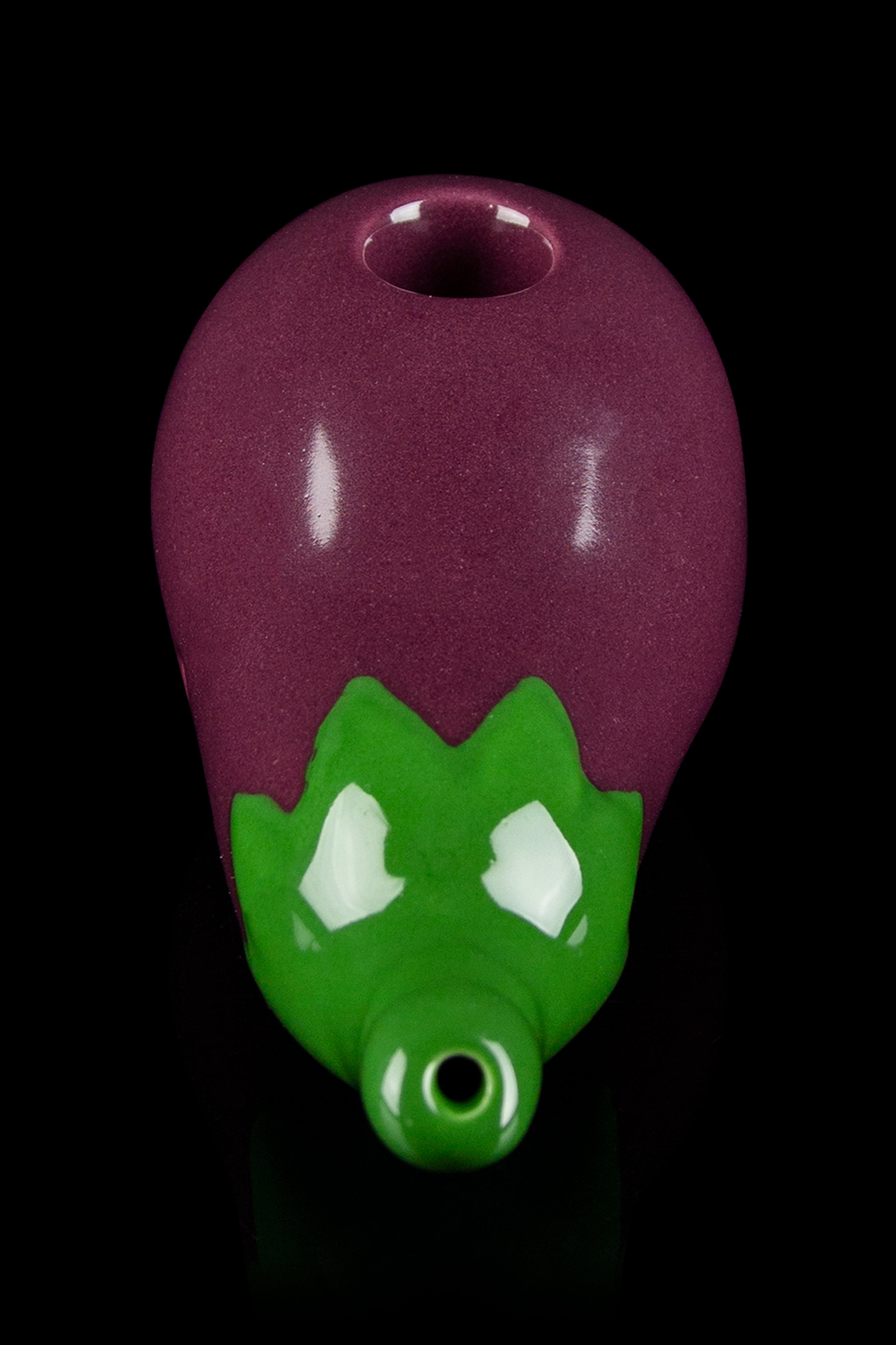 Glass pipe shaped like a dragon's head, featuring a burgundy body and green accents.