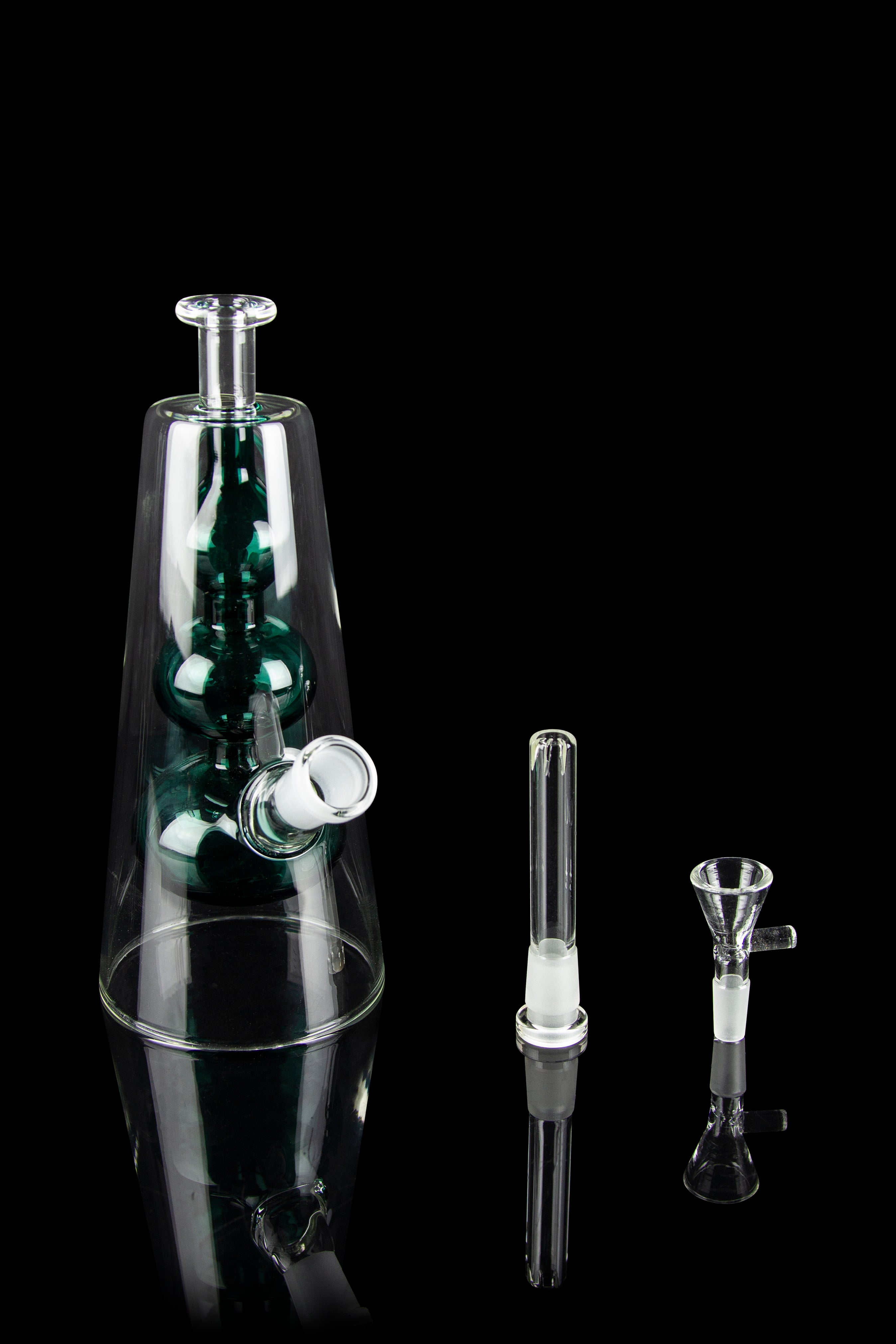 A glass water pipe (bong) with green accents, alongside two glass inserts, isolated on a black background.