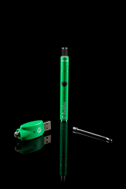 Vertical studio shot of a green Buddies Convertible 2-in-1 Battery & Dab Adapter with its USB charger and dab tool reflected on a black surface