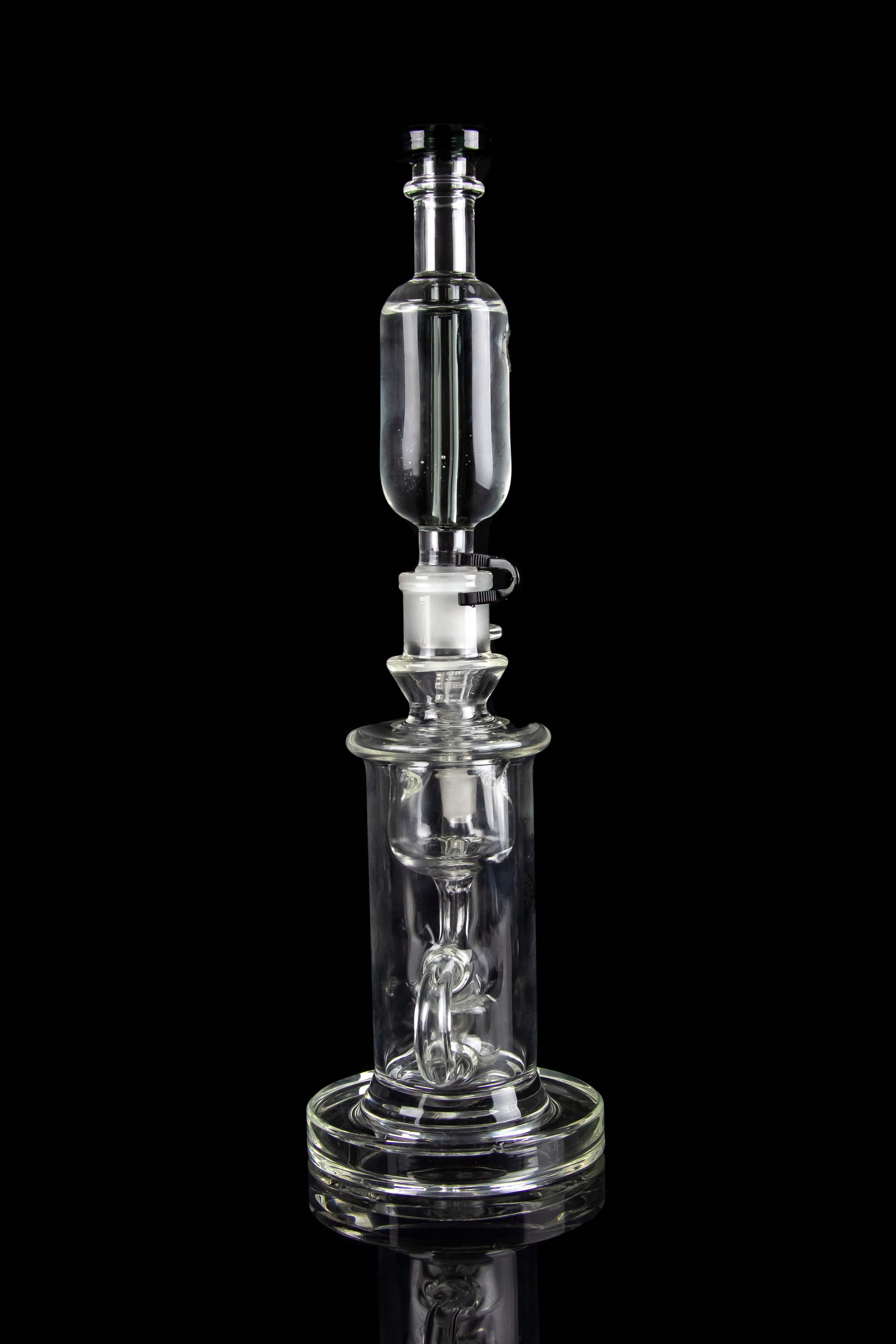 Clear glass dab rig with intricate percolator and bubbler components, isolated on a black background.