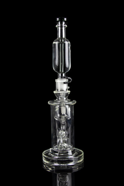 Clear glass dab rig with intricate percolator and bubbler components, isolated on a black background.