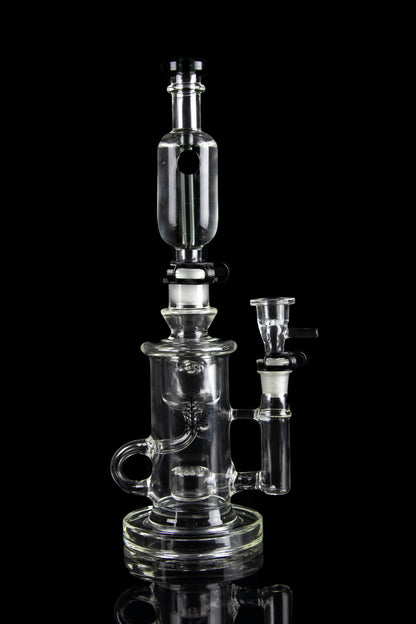 Clear glass water pipe (rig) with intricate branching percolators, against a black background.