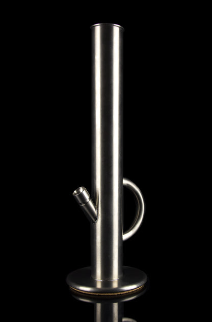 Polished metal cannabis bong against a black background.