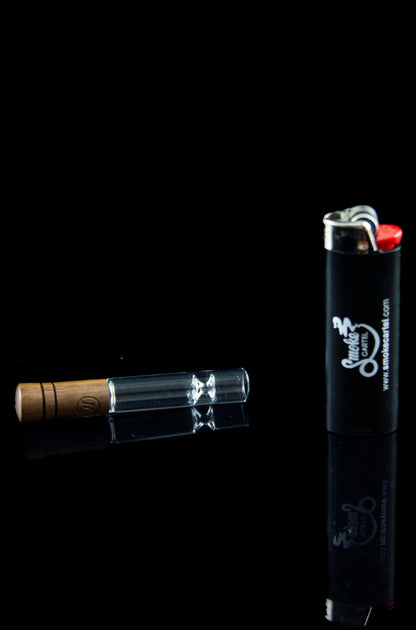 Glass oil burner pipe and lighter on a black background.