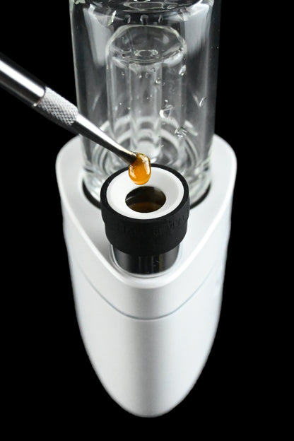 Dab rig with cannabis concentrate being applied to the heating element.