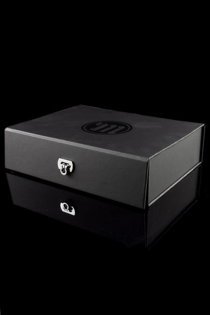 Black locked cannabis storage box with reflective surface.