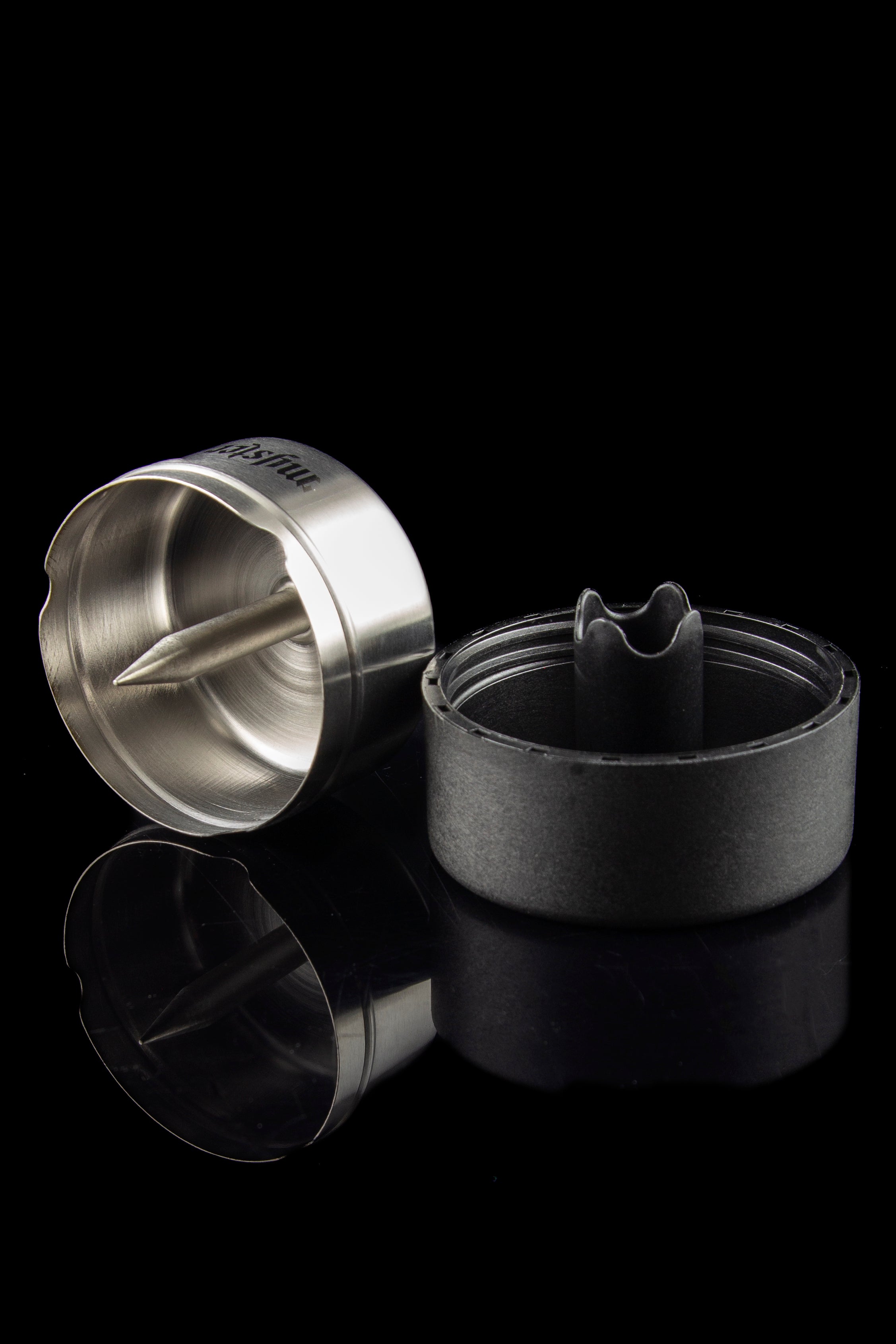 Silver and black cannabis concentrate extraction tool with a reflective surface.