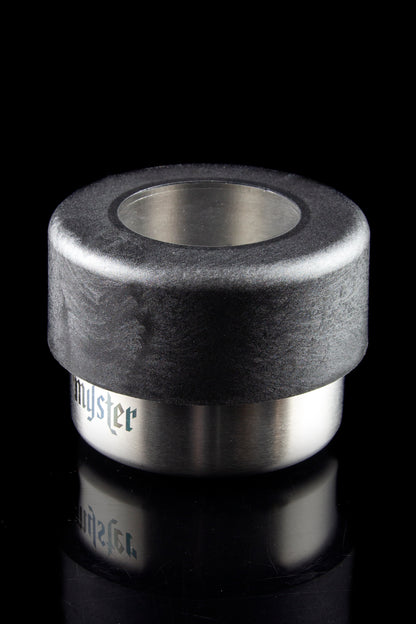 Sleek, cylindrical cannabis concentrate container with a black textured top and mirrored stainless steel base labeled "myster."
