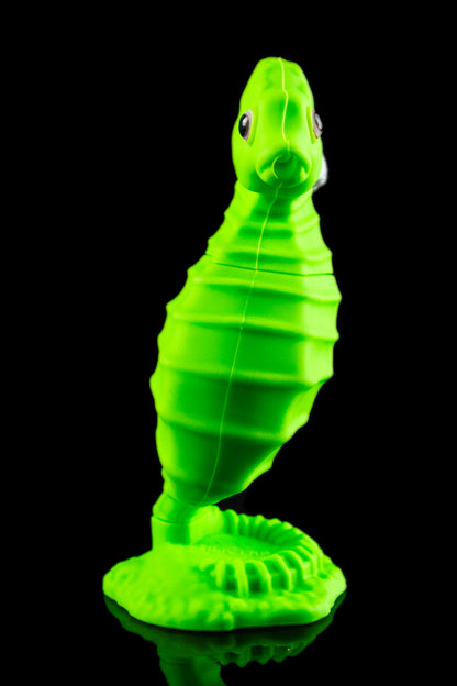 Neon green seahorse-shaped water pipe against a black background.