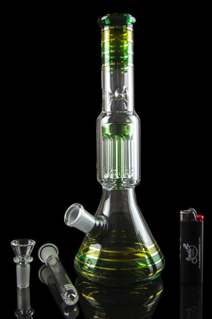 A vibrant green glass bong with a percolator base, alongside glass bowls and a lighter, set against a black background.