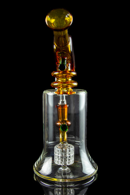 A detailed glass rig with orange and clear glass components, featuring a honeycomb perc diffuser and a spherical mouthpiece, set against a black background.