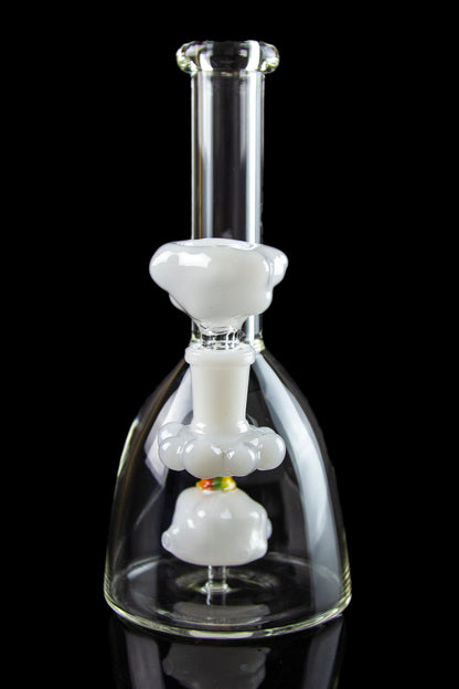 Glass bubbler water pipe with white percolator chambers against a black background.