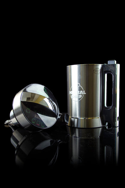 Stainless steel Herbal Chef infusion appliance with digital control panel, reflecting on a glossy black surface.