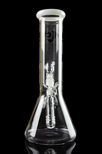 Clear glass bong with intricate sculpted artwork inside, reflecting on a glossy black surface.