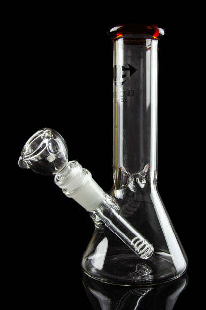Front view of the Diamond Glass 8" Classic Beaker Bong, reflecting light on its clear glass surface against a dark background.