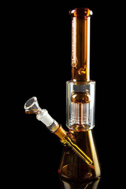 Amber glass water pipe (bong) with a clear glass bowl against a black background.