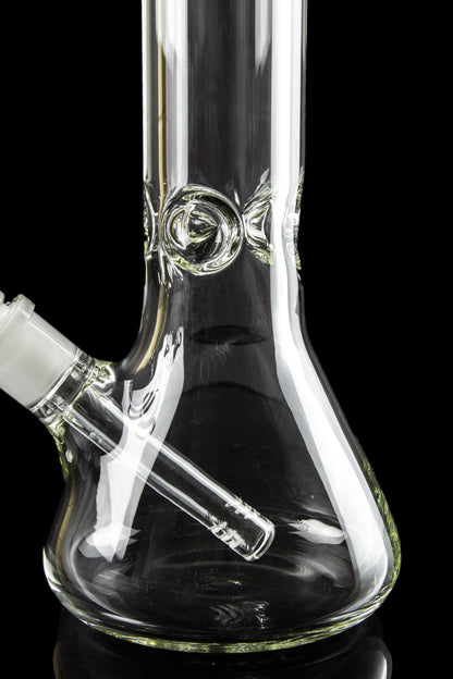 Clear glass water pipe (bong) with intricate design against a black background.