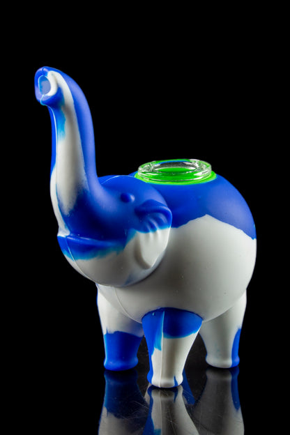 Front view of the Silicone Elephant Bubbler Pipe - Ellie, a pale blue, sculpted elephant form reflecting on a glossy black surface.